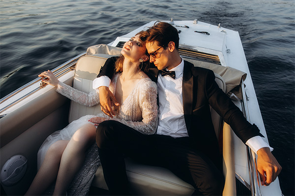 amorette international - companion for exclusive events - elegant couple on a boat