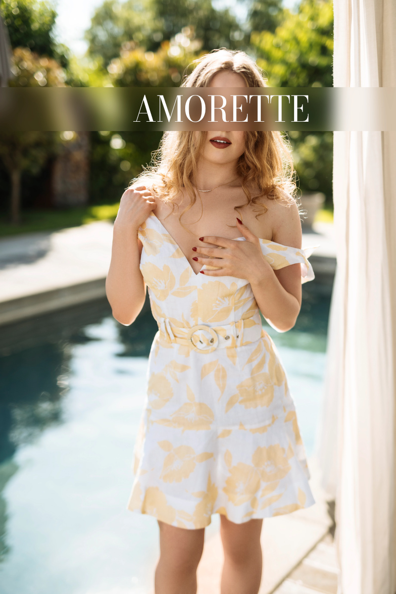 celine – open minded escort stockolm 23 elite escort model celine from stockholm standing in front of the pool in a white dress with floral pattern and holds her breast with one hand