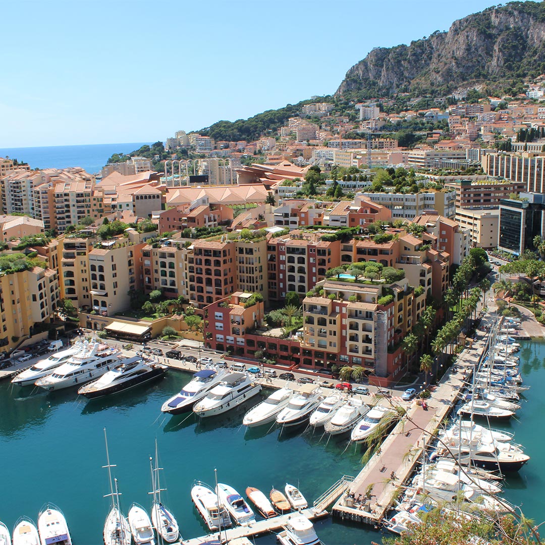 amorette international elite escort agency in monaco, high class escort service, elite escort service, luxury traveling, harbour, yachts and boats in the hrabour of monaco, blue sky, blue water, buildings, luxury, summer
