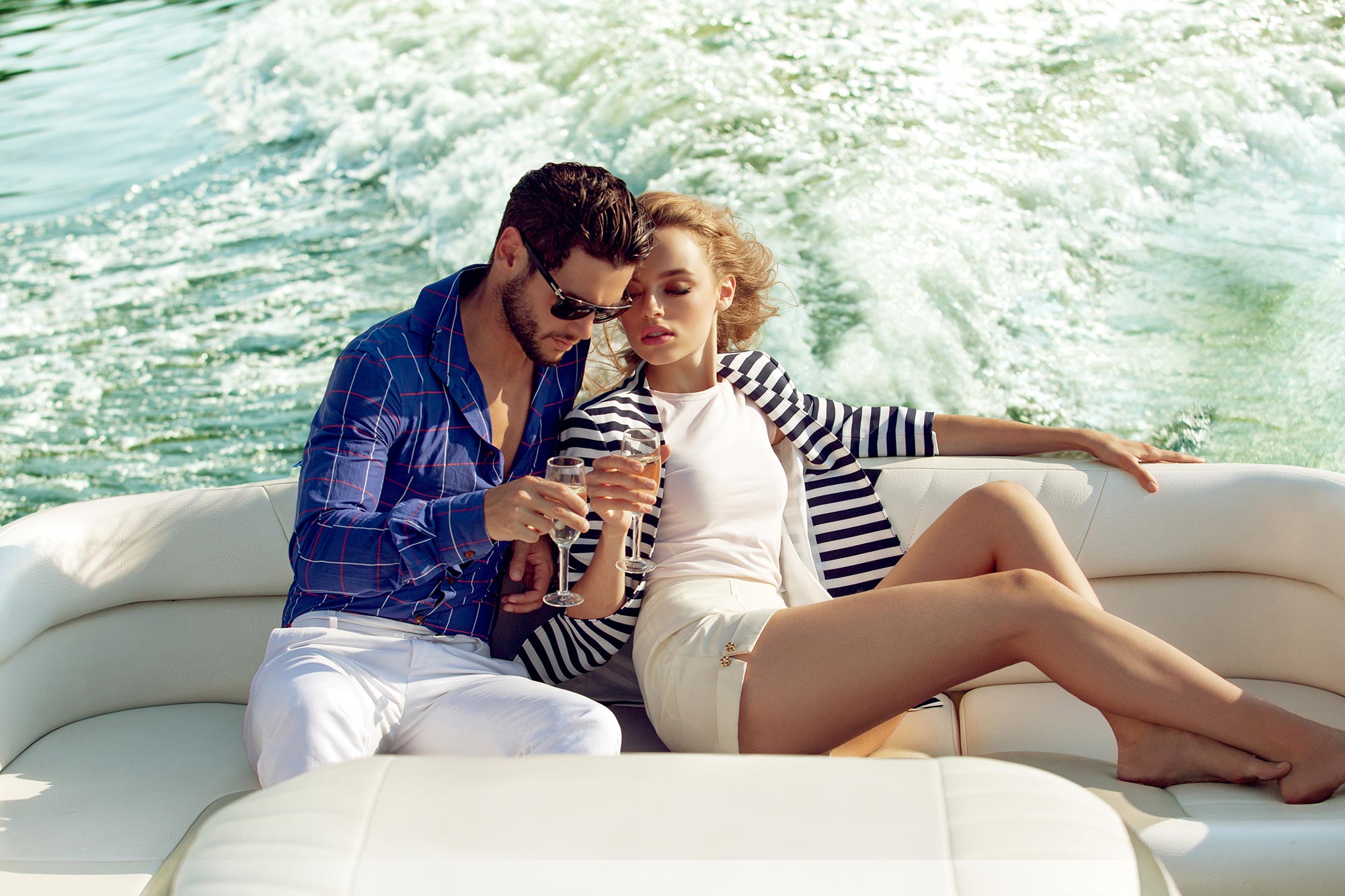 amorette international elite escort agency, high class escort service, couple on a boat, summer, vacation, traveling, elegant couple, yacht, blue shirt, white shirt, summer, luxury.