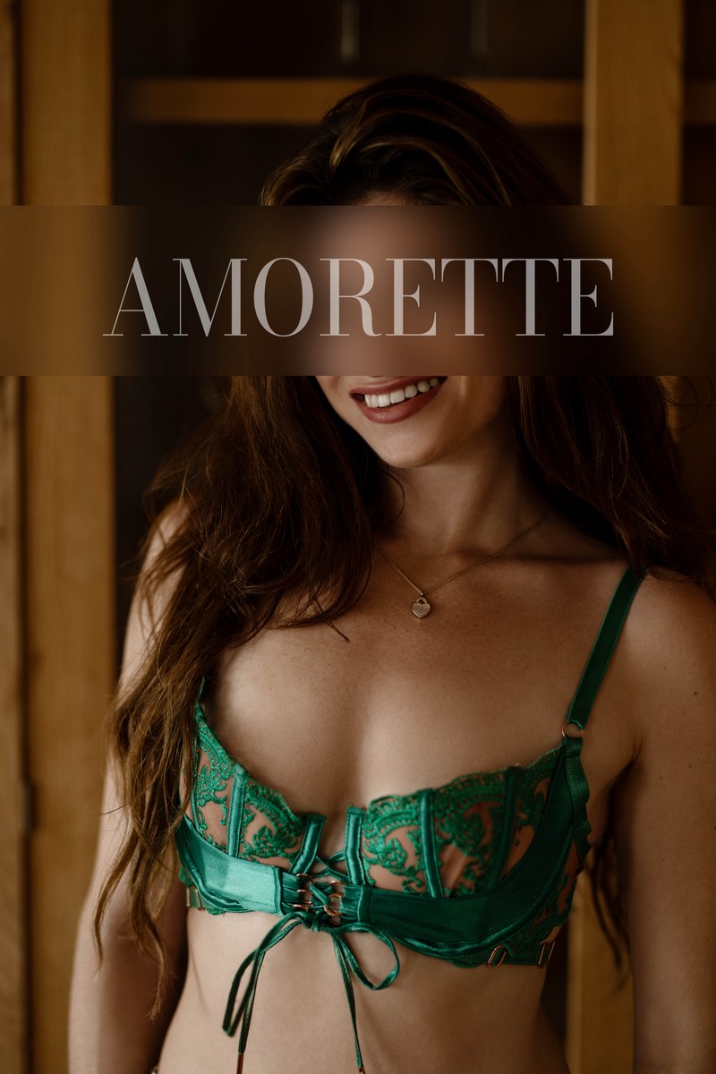 Ellie – Elite Escort Model from Florida Elite escort model Ellie from Florida exudes sophistication and charm in an intimate, softly styled interior. She wears elegant green lace lingerie that highlights the refined lines and natural contours of her figure, combining sensuality with premium elegance. Her long hair cascades gracefully around her shoulders, and her warm, inviting smile radiates confidence, poise, and international allure. The subtle, luxurious background complements her polished presence, emphasizing her natural beauty, elegance, and high-class persona. Soft lighting enhances the luxurious texture of the lingerie and the refined silhouette of her body, creating a captivating and sophisticated impression. High-class escort model, luxury, traveling, USA, America, international, elegant lingerie, lingerie, models.