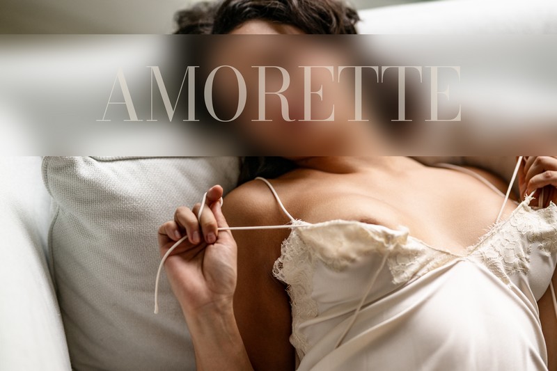 Ophelia – Elite Escort Model from Berlin Elite escort model Ophelia from Berlin reclines gracefully on a light-colored sofa, wearing a delicate, silky camisole with thin straps that accentuate the refined lines of her upper body. She adjusts the strap softly with one hand, creating a natural, elegant gesture that emphasizes her polished posture and smooth contours. The close perspective highlights her feminine silhouette while keeping the composition sophisticated and tasteful. Soft natural light fills the space, casting gentle highlights across her skin and the luxurious fabric, enhancing her serene and confident presence. Her shoulder-length dark brown hair frames her features beautifully, and her subtle, inviting expression radiates charm, warmth, and premium allure. The soft, elegant interior underscores her natural beauty, poise, and international sophistication. Luxurious, captivating, travel-ready, premium escort, Germany.