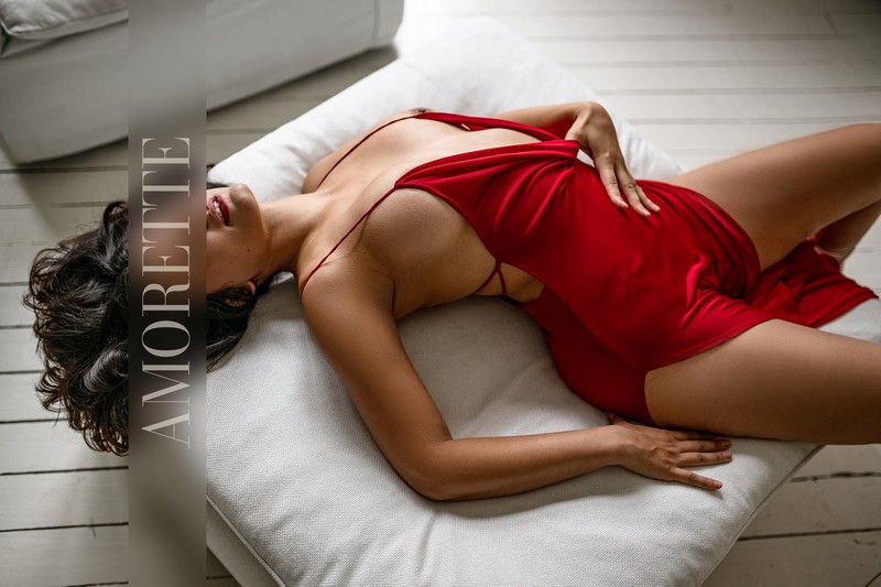 orphelia premium escort berlin 4 Elite escort model Ophelia from Berlin reclines gracefully on her back, wearing a flowing long red dress with thin straps. She gently adjusts the dress to reveal her elegant décolletage, creating a sophisticated and refined pose that emphasizes the smooth, natural curves of her silhouette. Soft natural light bathes the scene, highlighting the polished lines of her figure and the luxurious texture of the fabric. Her dark hair fans softly around her shoulders, framing her serene, confident expression that radiates charm, warmth, and premium allure. The bright, neutral interior subtly enhances her presence, showcasing her natural beauty, elegance, and international sophistication. Luxurious, captivating, travel-ready, premium escort, Germany.